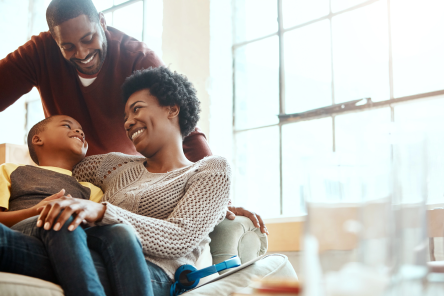 A happy family sitting in the living room of a house