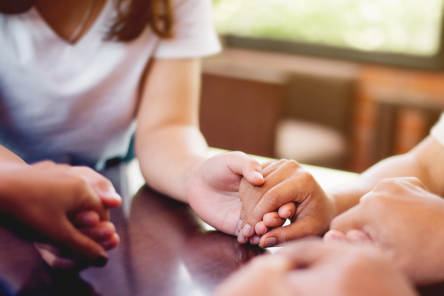 photo of a woman holding a man&#039;s hand