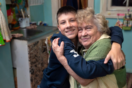 A boy hugging his grandmother